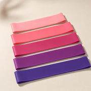Five flat closed-loop bands arranged from pale pink through magenta and plum to deep purple.